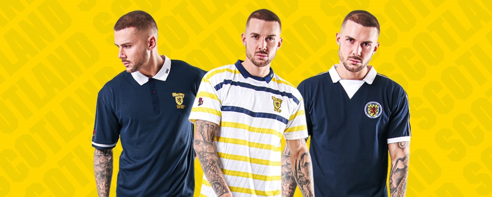 Three models showcasing various polo shirts against a vibrant yellow background featuring the word 'SCOTLAND'. The shirts include a navy blue option with a logo, a striped yellow and white design, and another navy blue polo.